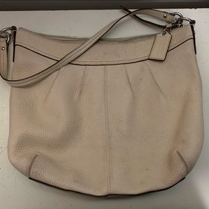 This is a super cute. Ivory coloured crossbody Coach bag!